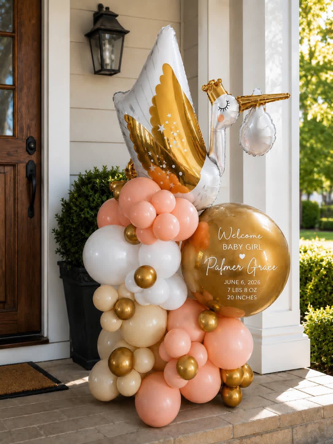 Stork marquee with peach, ivory and chrome gold front porch display
